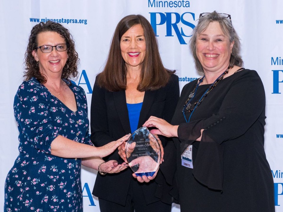 Debra Peterson, APR, Fellow PRSA (center) receiving PRSA Midwest District Platinum Award from PRSA Greater Kansas City chapter president Bridget Koan (left) and PRSA Midwest District chair Eva Keiser, APR (right). 